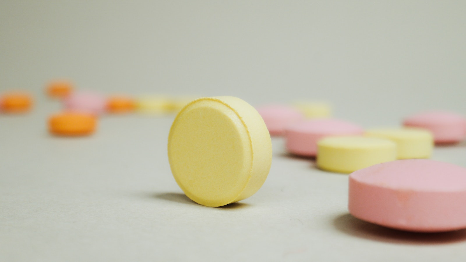 Colorful Round Pills on White Surface